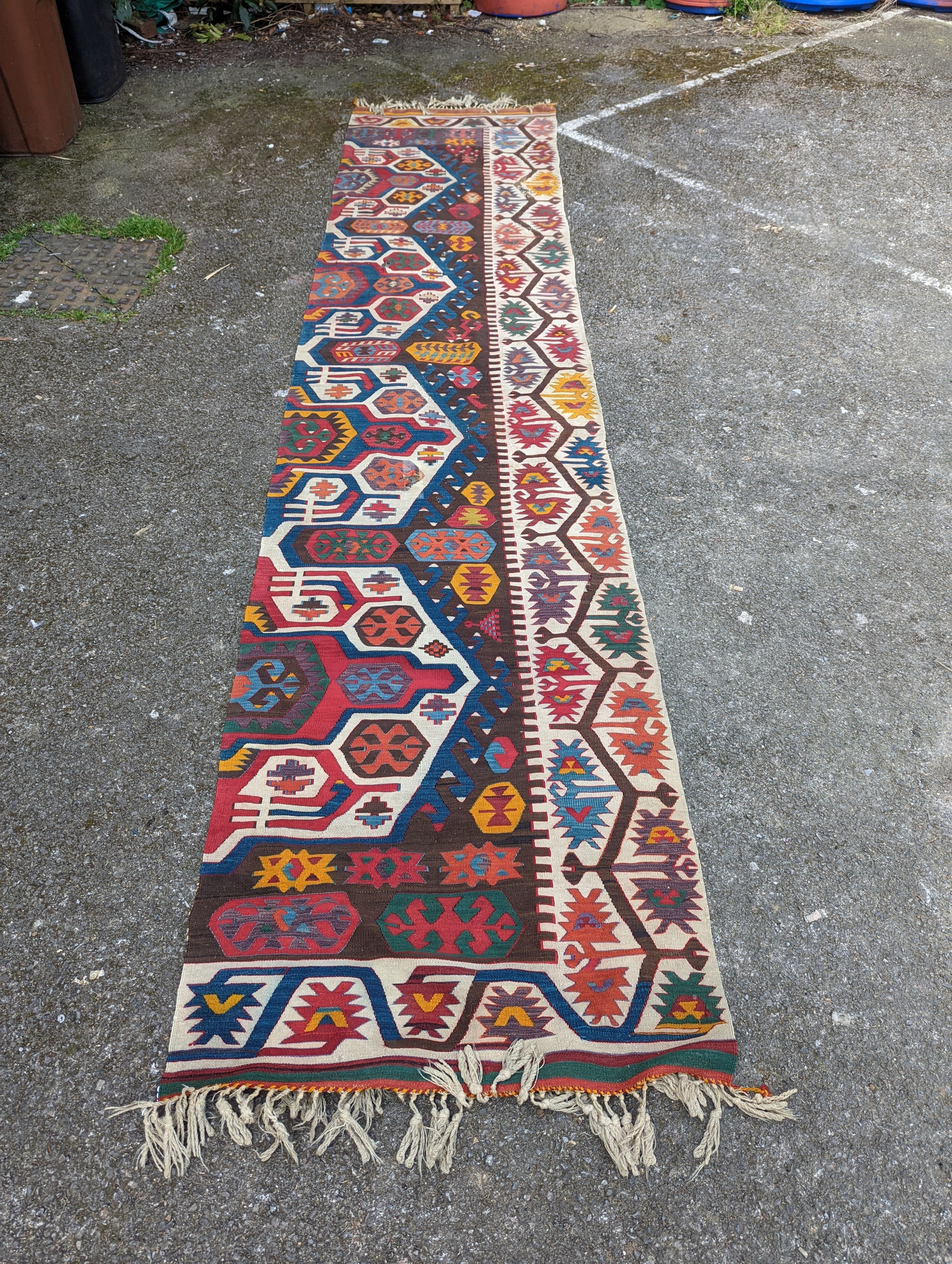 A large Kilim flatweave runner, 400 x 92cm (holed and cut)